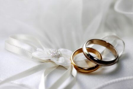 Wedding Rings on white satin - stock image